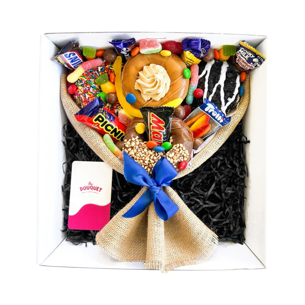 Small Men's Deluxe Donut Bouquet with assorted donuts, mini chocolates, and colourful lollies, wrapped with a blue ribbon.